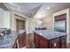 Open kitchen with granite countertops, dark wood cabinets, and island at 1041 Viale Placenza Pl, Henderson, NV 89011