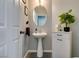 Stylish powder room with pedestal sink and modern vanity at 10437 Lyric Arbor Dr, Las Vegas, NV 89135