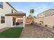 Landscaped backyard with covered patio, artificial turf, and mountain views at 10478 Precliffs Ct, Las Vegas, NV 89129