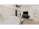 Bright bedroom with a king-size bed and ensuite bathroom access at 10478 Precliffs Ct, Las Vegas, NV 89129