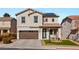 Two-story house with solar panels, landscaped yard, and a brown three-car garage at 10478 Precliffs Ct, Las Vegas, NV 89129