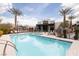 Resort-style pool with lounge chairs and palm trees provides an oasis for relaxation and entertainment at 11431 Gravitation Dr # 102, Las Vegas, NV 89135