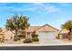 Single-story house with a two-car garage and landscaped front yard at 1835 Candle Bright Dr, Henderson, NV 89074