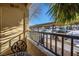 Private balcony with wrought iron furniture and view of the covered parking area at 2120 Ramrod Ave # 1112, Henderson, NV 89014