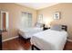 Twin bedroom with hardwood floors and neutral colored walls at 2120 Ramrod Ave # 1112, Henderson, NV 89014
