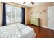 Inviting bedroom with hardwood floors, large window, and stylish decor at 2120 Ramrod Ave # 1112, Henderson, NV 89014