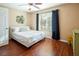 Bright bedroom featuring hardwood floors and a large window with dark curtains at 2120 Ramrod Ave # 1112, Henderson, NV 89014