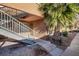 Exterior view of the property featuring stairs leading to a second-story unit and desert landscaping at 2120 Ramrod Ave # 1112, Henderson, NV 89014