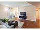 Spacious living room with sliding door access to a balcony and modern entertainment center at 2120 Ramrod Ave # 1112, Henderson, NV 89014