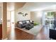Comfortable living room featuring a plush sofa, sliding door access to balcony, and stylish decor at 2120 Ramrod Ave # 1112, Henderson, NV 89014