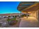 Covered patio with desert landscaping, stone pathway, and mountain views at 2220 Canyonville Dr, Henderson, NV 89044