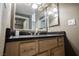 Bathroom vanity featuring a dark countertop, framed mirror, and sleek faucet for a touch of modern elegance at 230 E Flamingo Rd # 212, Las Vegas, NV 89169