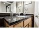 Bathroom vanity showcasing a sleek dark countertop, modern faucet, and decorative accents for a touch of elegance at 230 E Flamingo Rd # 212, Las Vegas, NV 89169