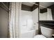 Bathroom with a tub and shower, complemented by a vanity with dark countertop and ample natural light at 230 E Flamingo Rd # 212, Las Vegas, NV 89169