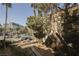 Building exterior complemented by palm trees, landscaping, and visible parking showcases an urban living community at 230 E Flamingo Rd # 212, Las Vegas, NV 89169