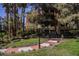 Multi-story building surrounded by trees, green grass and a blue sky overhead at 230 E Flamingo Rd # 212, Las Vegas, NV 89169