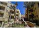 Exterior view of building with tropical landscaping and community entrance at 230 E Flamingo Rd # 212, Las Vegas, NV 89169