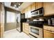 Kitchen showcasing stainless steel appliances, including a refrigerator and stove, with light wood cabinets at 230 E Flamingo Rd # 212, Las Vegas, NV 89169