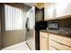 Kitchen featuring stainless steel refrigerator, light wood cabinets, and dark countertops by a window at 230 E Flamingo Rd # 212, Las Vegas, NV 89169