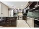 Well-appointed kitchen with modern appliances, granite countertops, custom cabinetry, and tile backsplash at 230 E Flamingo Rd # 212, Las Vegas, NV 89169