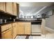 Kitchen featuring light wood cabinets, dark countertops, and stainless steel dishwasher, with a view to another room at 230 E Flamingo Rd # 212, Las Vegas, NV 89169