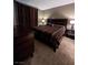 Bedroom showcasing striped bedding, two side tables and dark brown dresser at 230 E Flamingo Rd # 212, Las Vegas, NV 89169