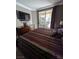 Bedroom with striped bedding, dresser with TV and a glass sliding door at 230 E Flamingo Rd # 212, Las Vegas, NV 89169