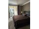 Bedroom featuring striped bedding, sliding door to outdoor seating, and neutral walls at 230 E Flamingo Rd # 212, Las Vegas, NV 89169