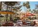 Inviting outdoor seating area with comfortable furnishings, umbrellas, and lush landscaping for relaxation and enjoyment at 230 E Flamingo Rd # 212, Las Vegas, NV 89169