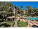 Lush pool area featuring cozy cabanas, lounge chairs, and beautiful landscaping for a serene outdoor retreat at 230 E Flamingo Rd # 212, Las Vegas, NV 89169