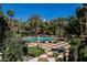 Inviting pool area surrounded by palm trees, lounge chairs, and a checkered patio, creating a resort-like atmosphere at 230 E Flamingo Rd # 212, Las Vegas, NV 89169