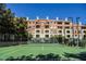 Well-maintained tennis court surrounded by trees with clear sky overhead at 230 E Flamingo Rd # 212, Las Vegas, NV 89169