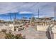 Community outdoor grilling area with built-in grills, concrete benches, and overhead string lights at 2657 Champagne Gold Ave, North Las Vegas, NV 89086