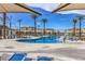 Community pool area with lounge chairs and umbrellas providing a relaxing outdoor space for residents at 2657 Champagne Gold Ave, North Las Vegas, NV 89086
