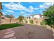 Landscaped backyard with gravel, artificial turf, and stone pathway at 3094 Isle Dr, Las Vegas, NV 89141