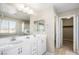 Bathroom with double vanity, large mirror, and walk-in shower at 3094 Isle Dr, Las Vegas, NV 89141