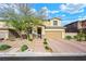 Two-story house with tan exterior, brick driveway, and landscaping at 3094 Isle Dr, Las Vegas, NV 89141