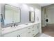 Elegant bathroom featuring double sinks, quartz countertops, and wood flooring at 3146 Bel Air Dr, Las Vegas, NV 89109