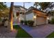 Inviting residence featuring an attached garage, a beautiful archway, manicured landscaping, and a serene atmosphere at 3146 Bel Air Dr, Las Vegas, NV 89109