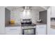 Kitchen area with granite countertop, stainless steel range hood, and tiled backsplash at 3146 Bel Air Dr, Las Vegas, NV 89109