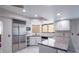 Corner kitchen featuring stainless steel appliances, white cabinets, and tile backsplash at 3146 Bel Air Dr, Las Vegas, NV 89109