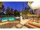 Relax in this inviting pool and patio area, complete with a table, chairs, and lush greenery at 3146 Bel Air Dr, Las Vegas, NV 89109