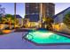 Inviting pool area with turquoise water, palm trees, and a modern condo in the background at 3146 Bel Air Dr, Las Vegas, NV 89109