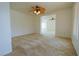 Spacious bedroom with ceiling fan and access to another room at 3921 Buteo Ln, North Las Vegas, NV 89084