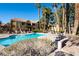 Community pool with surrounding patio furniture at 2120 Ramrod Ave # 1112, Henderson, NV 89014