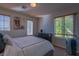 Bright bedroom with two windows and a dresser at 10892 Toscano Gardens St, Las Vegas, NV 89141