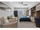 Inviting bedroom with a sleek ceiling fan, built-in shelving, cozy seating, and a serene atmosphere at 305 Via Del Duomo, Henderson, NV 89011