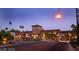 Well-manicured community entrance with decorative stone architecture and lush landscaping at 305 Via Del Duomo, Henderson, NV 89011