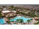 Aerial shot of a large community pool and clubhouse surrounded by palm trees at 305 Via Del Duomo, Henderson, NV 89011