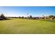 View of a well-maintained golf course putting green, surrounded by trees at 305 Via Del Duomo, Henderson, NV 89011